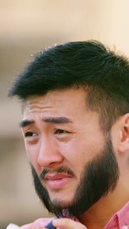 man sneezing into a tissue
