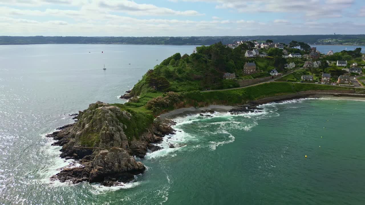 Sideways backward drone movement of the endpoint of Pointe du Chateau northerly point in Perros-Guirec beachside, Côtes-d'Armor, Brittany, France.