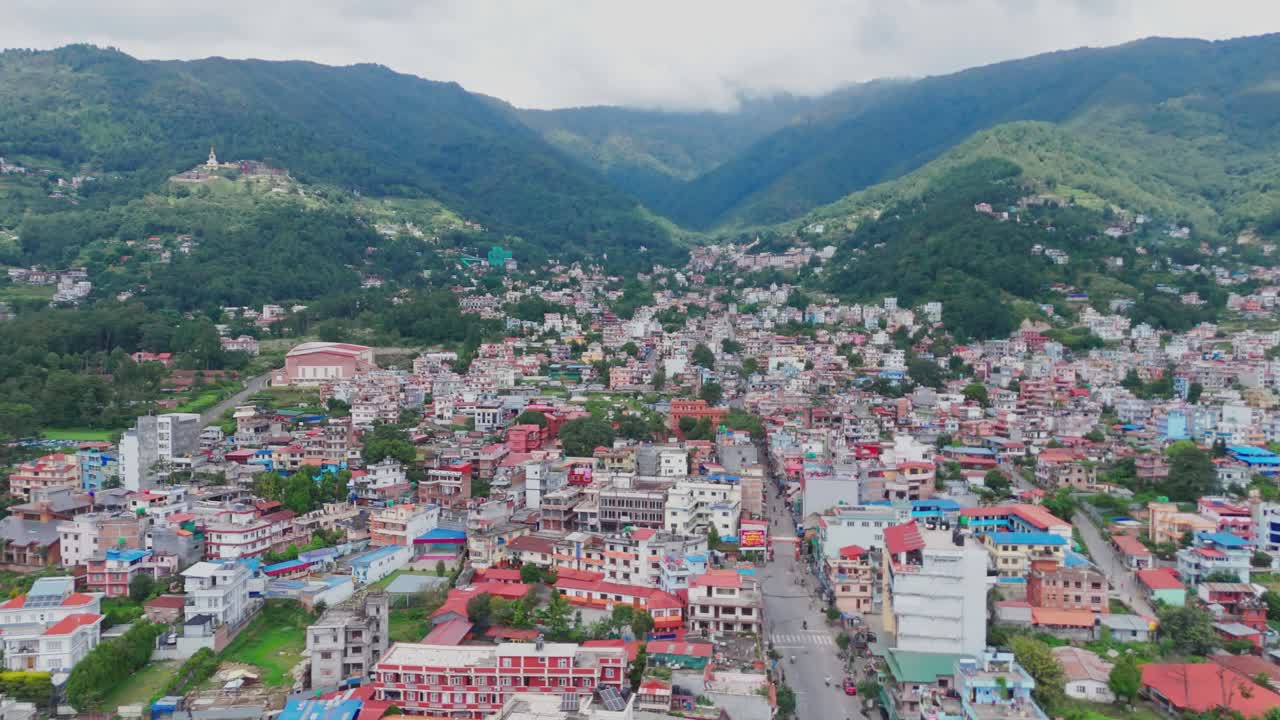 Aerial drone footage of Budhanilkantha in Kathmandu Valley, Nepal, showcasing city settlements, green hills, and scenic mountain landscapes from above