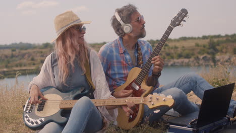 couple playing music outdoors