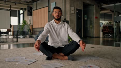 businessman meditating in office