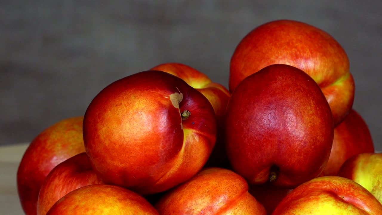 Pile of ripe nectarine fruits. Healthy nutrition. turntable counterclockwise
