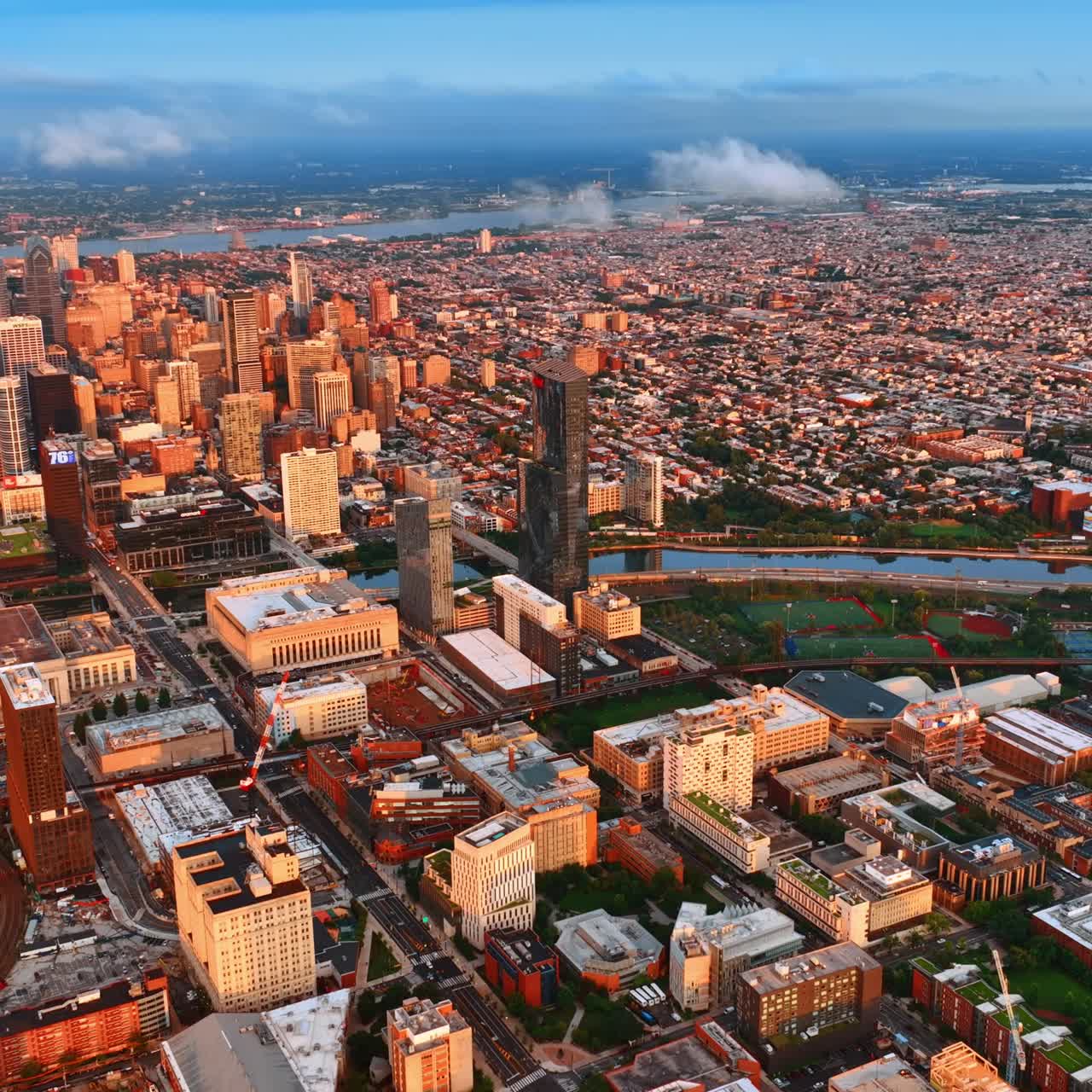 Sunlit Philadelphia panorama at daytime. Drone footage over the vast cityscape at sunset