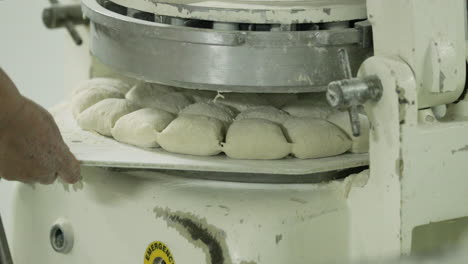 Dough-Divider-Machine-Cutting-Bread-Dough-Into-Pieces-Before-Baking---close-up