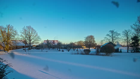 day to night timelapse of rural snowy landscape and moon rising up in sky