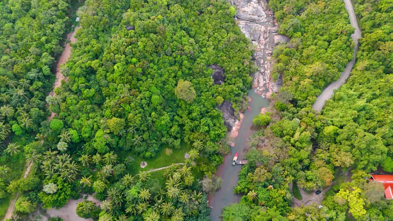 Drone footage reveals Koh Phangan's rainforest river leading to beach