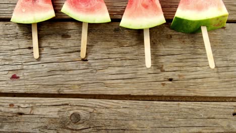 Slices-of-watermelon-arranged-on-wooden-table