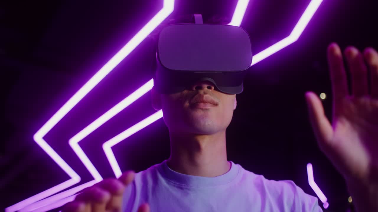 Man using VR headset in a neon lit environment