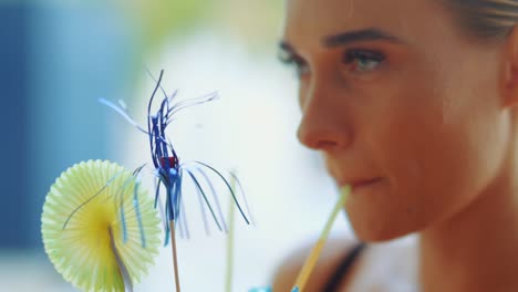 girl is drinking cocktail from a straw