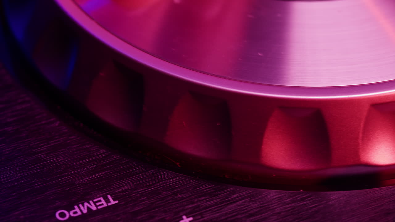 DJ with headphones and sunglasses playing music on festival in night club. Techno musician performing at nightclub for concert crowd of people, city bar.