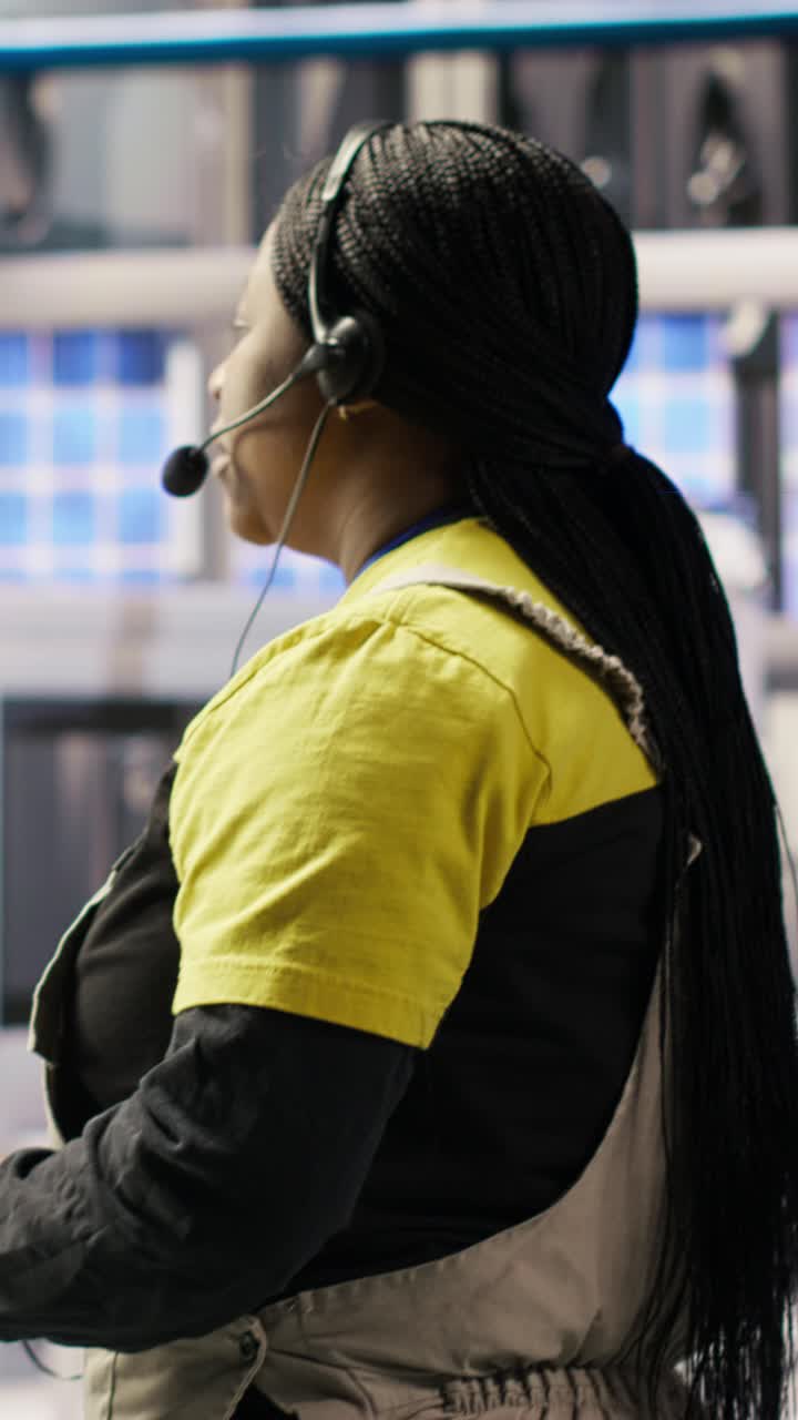 Vertical video Technician remotely supervising smart factory production lines