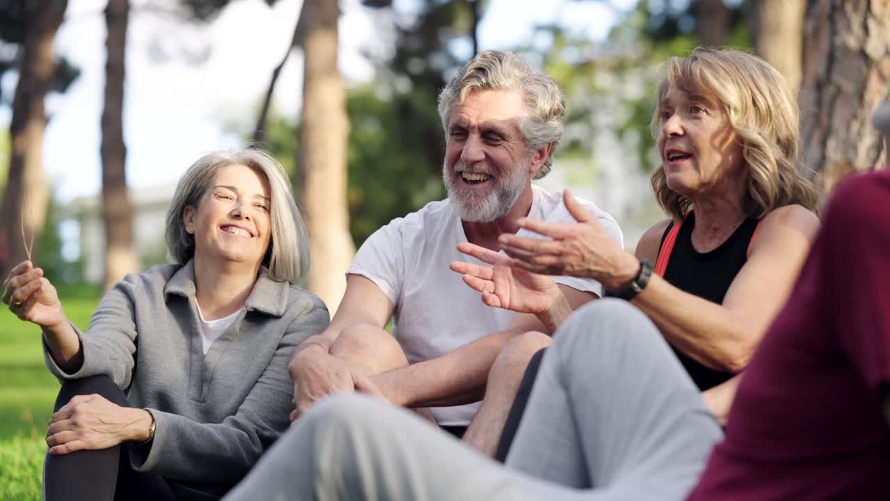 Group of People Sitting on Grass in Park