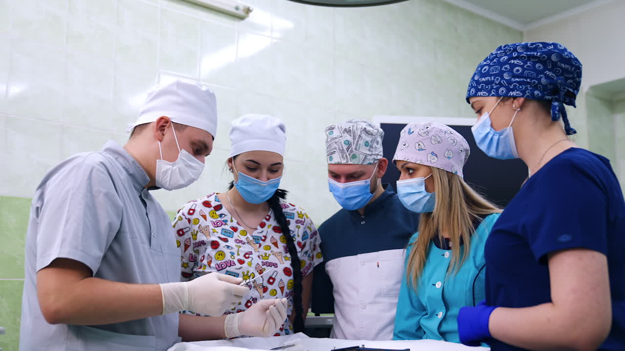 Group of dentistry department students listen to their teacher. Academic demonstrating a variety of tools to future dentists.