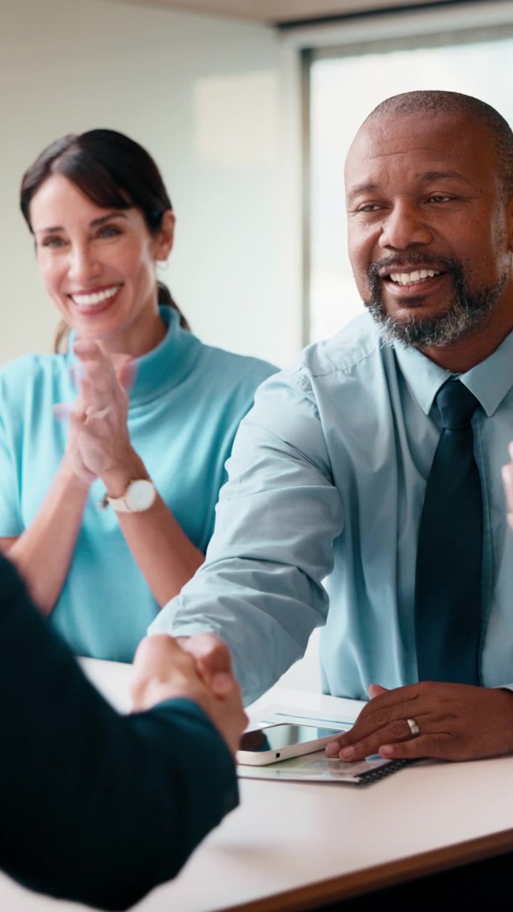 Business Professionals Shaking Hands During a Meeting