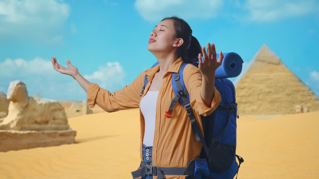 Side View Of Asian Female Hiker With Mountaineering Backpack Smiling And Spreading Arms Enjoy Looking The View Around While Traveling In Pyramid Of Giza