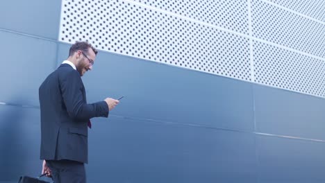 businessman walking while using phone.
