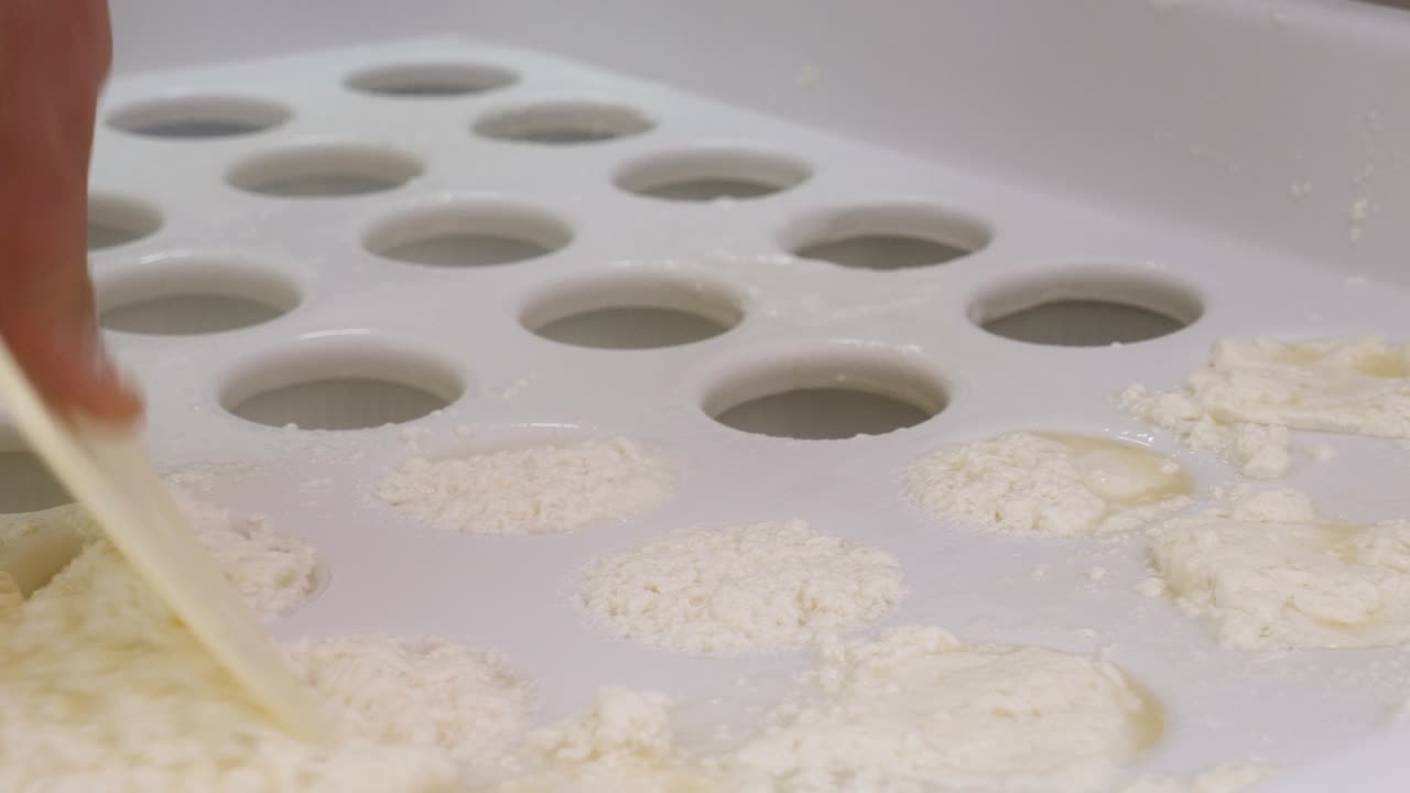 Dairy Cheese factory- putting the ricotta cheese in the molds