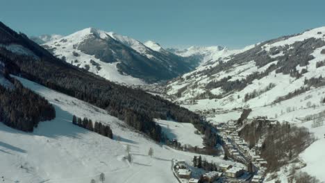 ski resort in snowy austrian alps mountains - aerial drone establisher