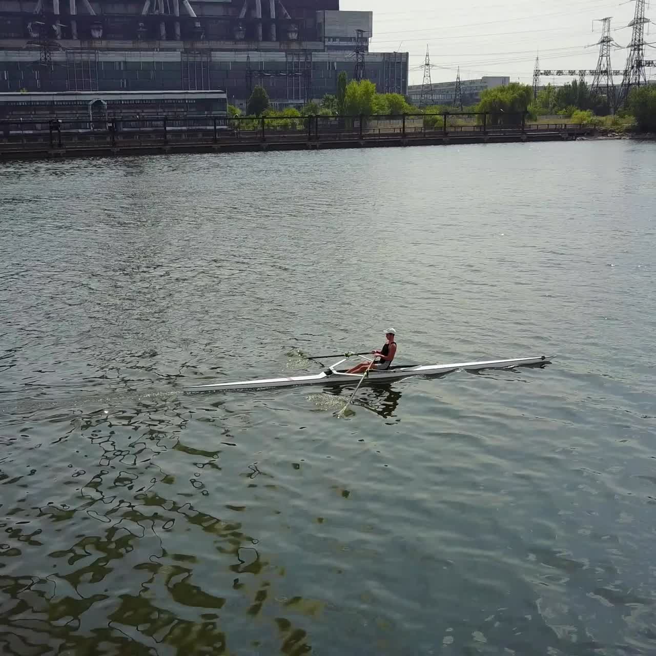 Training Athlete In Kayak. Training of small sportsmen rowers on a kayak on the river