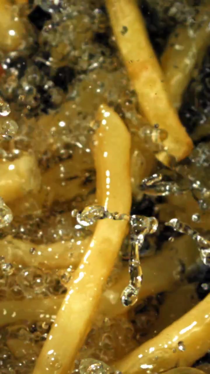 Golden French Fries Cooking in Bubbling Hot Oil