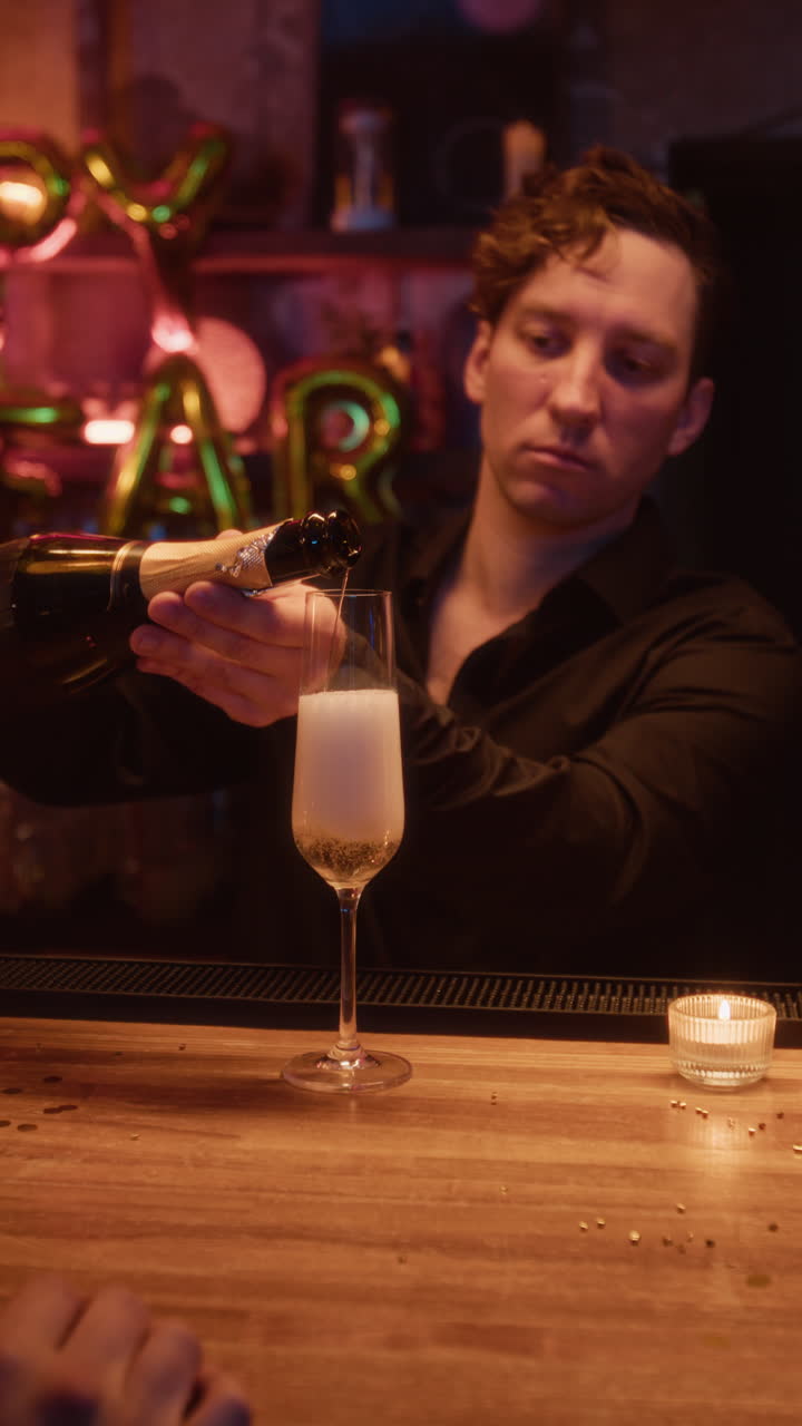 Bartender pouring champagne for New Year's celebration