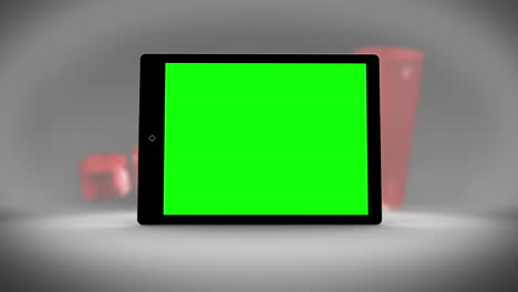 tablet with green screen in front of statistics