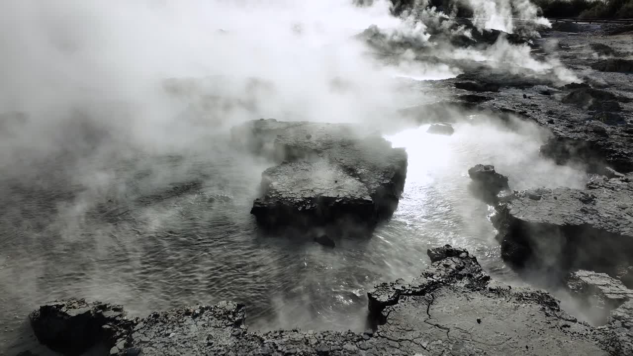 Bubbling mud, Drone slowly flying over geothermal landscape. Trees, steam, bubbling mud and steam. Alien Landscape. Sci-fi. Global Warming