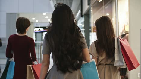 three female friends with paper bags