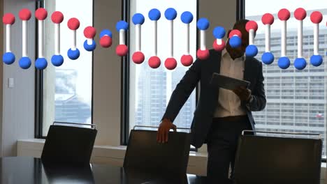 Animation-of-dna-strand-spinning-over-businessman-using-tablet