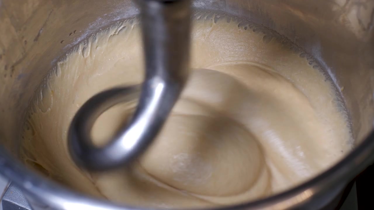 Industrial Mixer Machine With Wheat Dough Rotating In Bakery, organic artisan and vegan, gluten free bread dough, closeup in slowmotion