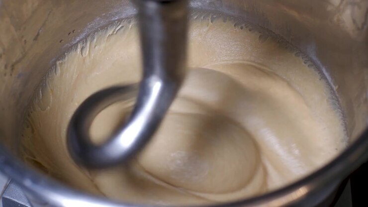 Industrial Mixer Machine With Wheat Dough Rotating In Bakery, organic artisan and vegan, gluten free bread dough, closeup in slowmotion