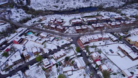 high angle birdseye view over the homes and buildings of pradera de navalhorno on a chilly snow-covered winter's day