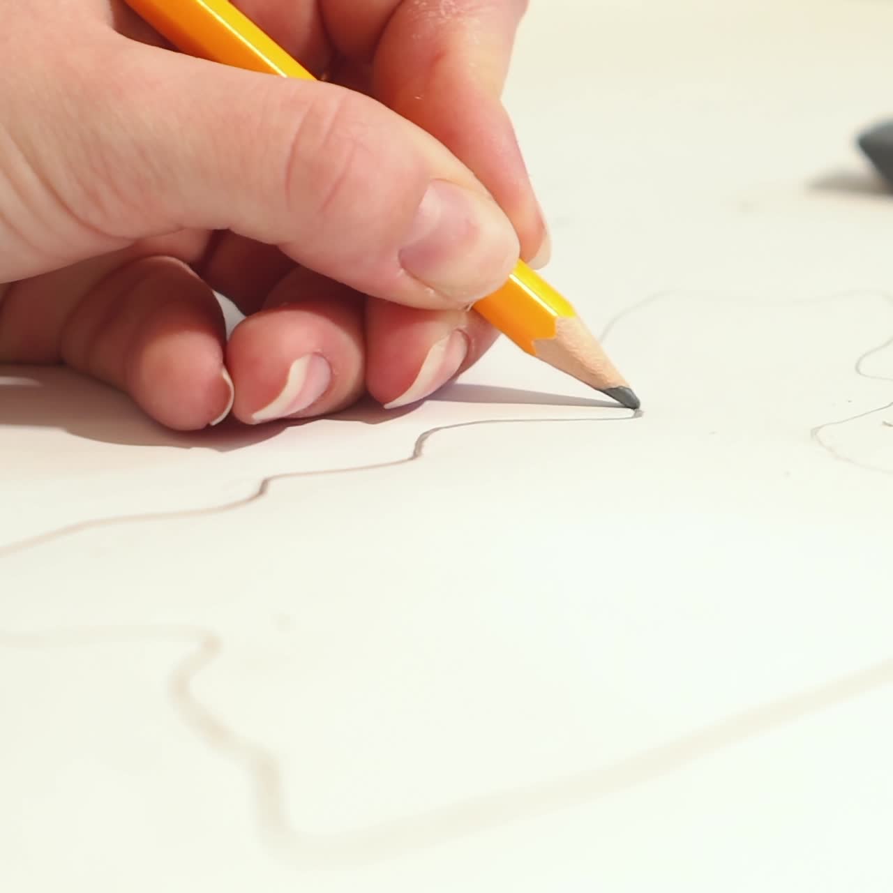 Woman is drawing with pencil sketch. Artist is working on a project.