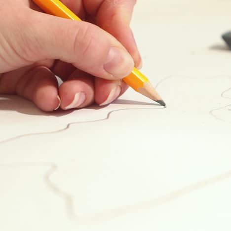 woman is drawing with pencil sketch. artist is working on a project.