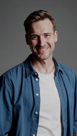 smiling man in denim shirt