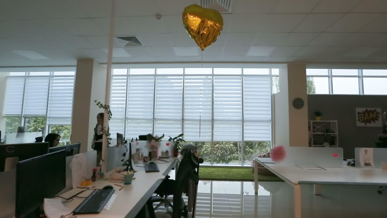 People Working In A Busy Office. Coworkers at their desks in a busy, open plan office