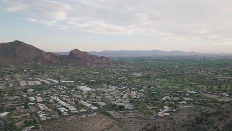 Drone-flying-over-mummy-mountain-and-revealing-Paradise-valley-of-Arizona-during-evening-in-USA