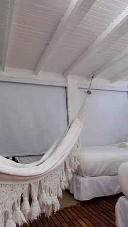 elegant white cotton woven handmade hammock hanging in the room. peaceful place