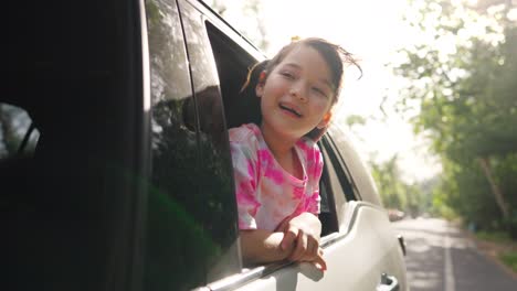 4k happy little asian girl enjoy and fun with family in the car on summer road trip vacation.