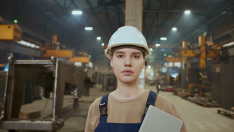 portrait of female technician with digital tablet during workday in industrial factory