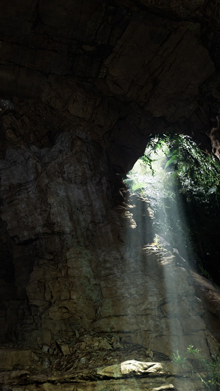 Light beams come through a rock opening in the forest during daytime