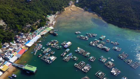 Drone-shot-traveling-forward-above-a-small-fisher-village-with-a-dock-and-oysters-farm-to-a-beautiful-little-river-delta-with-sea-mud-during-the-day