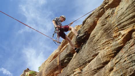 mounatineer rappelling down from the mounatin 4k