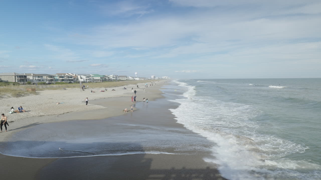 люди на пляже наслаждаются солнечным светом волны разбиваются о берег