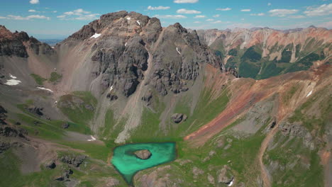 aerial drone cinematic high altitude ice lake basin island lake trail unreal blue water hike silverton ouray red mountain pass colorado dreamy heavenly rockies scene summer peaks forward circle motion
