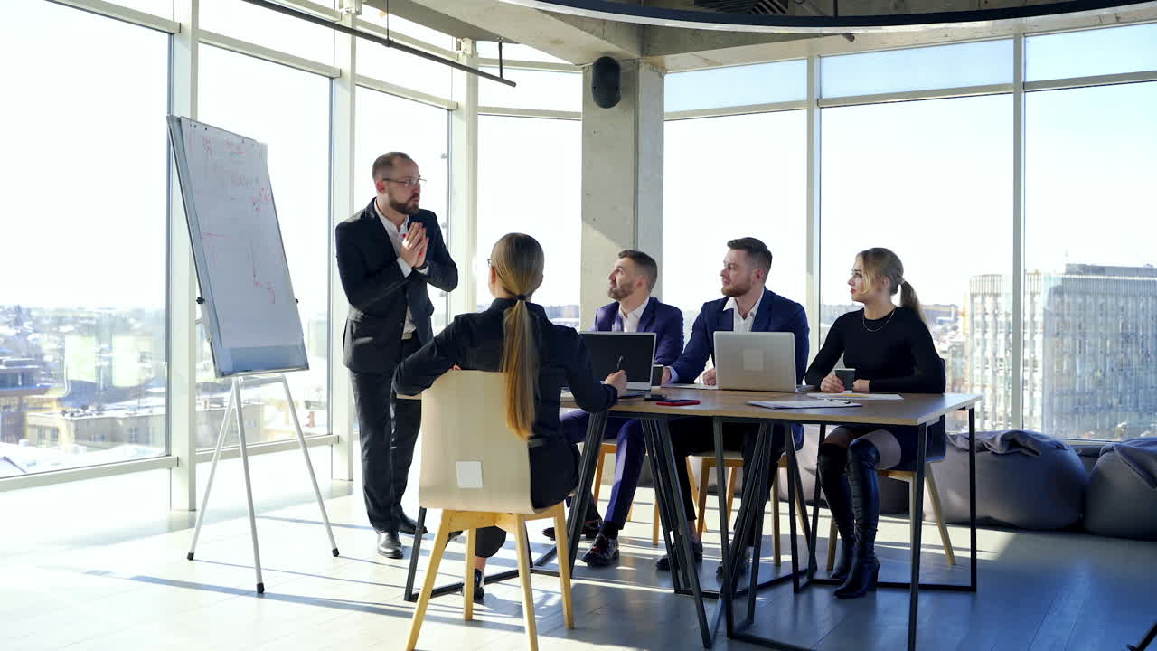 Colleagues employees working in office. Business partners cooperating together at a table. Team of business people meeting in modern office room.