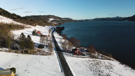 coastal road surrounded with snowy landscape during winter in norway