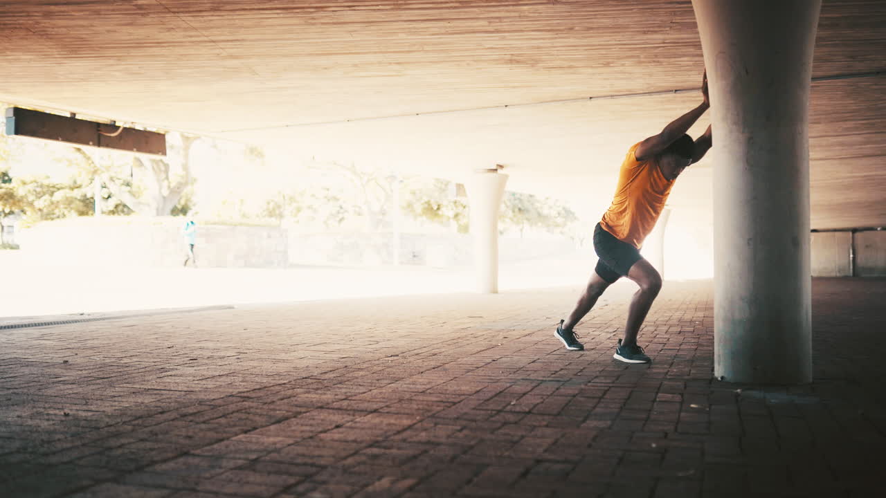 a sporty young man stretching while exercising