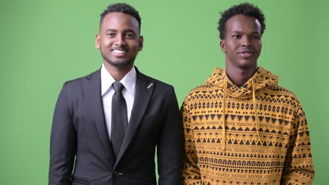 young african businessman and young african man together against green background