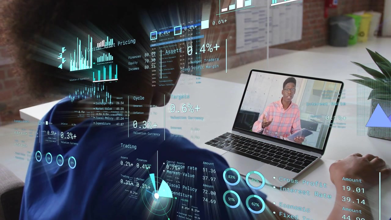 Viewer watching presenter talking, gesturing causing finance charts overlaying laptop for training